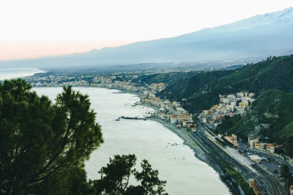 photo-1676943602355-5cd6a4e573c0.jpg Taormina with Mount Etna in view