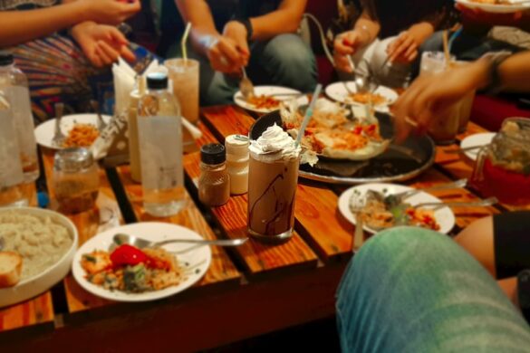 Guests enjoying paella at a restaurant.