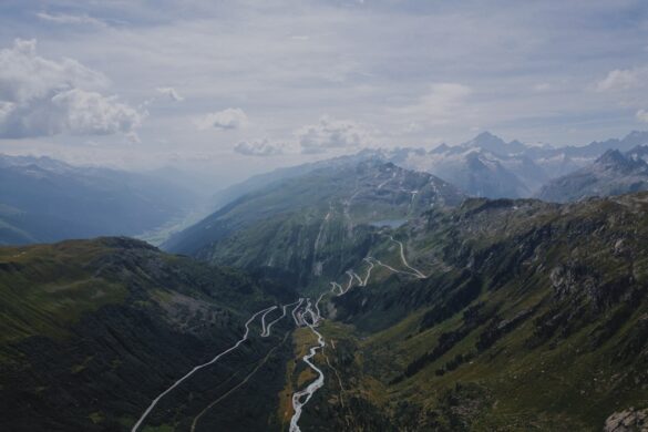 Mountain biker riding through Swiss valleys.