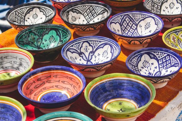 A craftsman showcasing intricate Moroccan pottery.