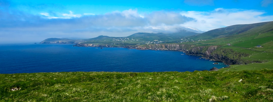 photo-1592662229638-d15729905642.jpg A scenic view of the Lake District with mountains and lakes.