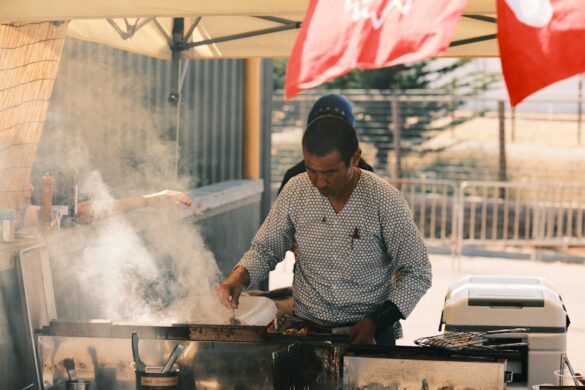 Making okonomiyaki on a hot grill