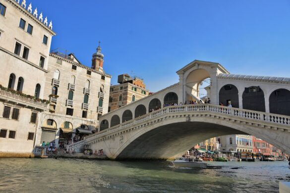 The famous Rialto Bridge with shops and a bustling market.